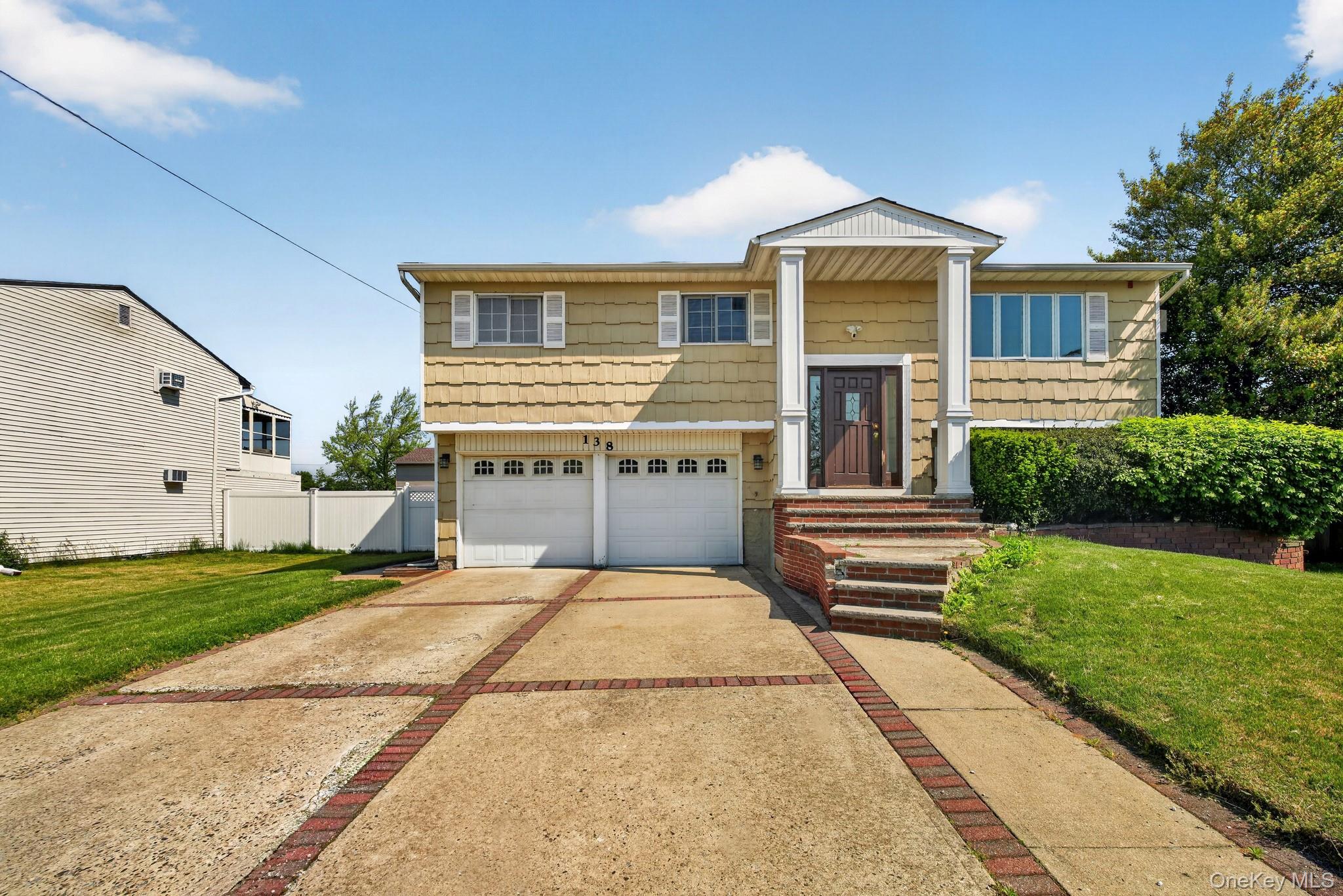 138 Spring Street Massapequa, NY 11758 - Photo 1 of 45 a front view of a house with garden