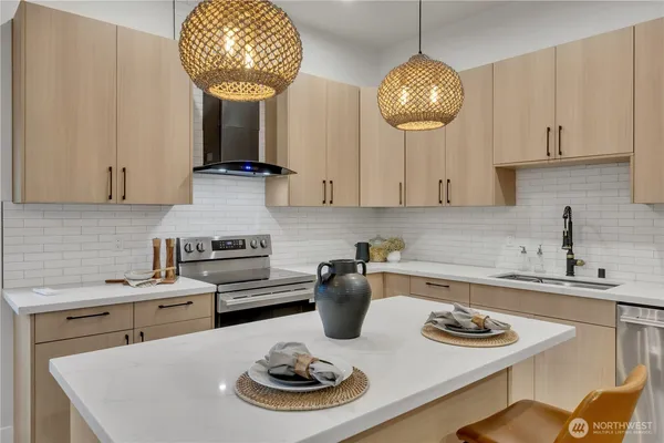 a kitchen with a sink cabinets and stainless steel appliances