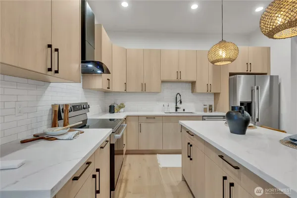 a kitchen with cabinets and chandelier