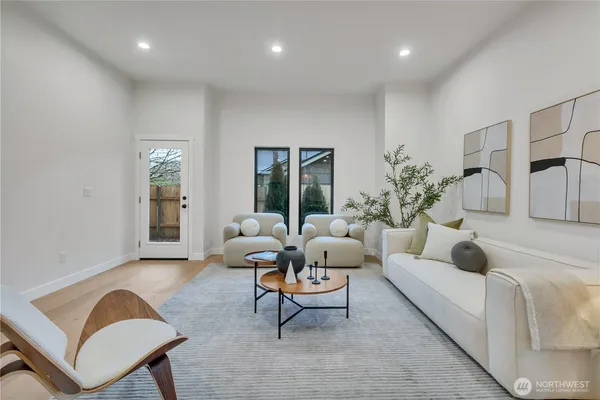 a living room with furniture and view of kitchen