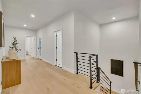 a spacious bedroom with a bed and glass door