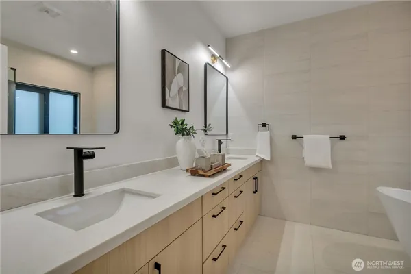 a bathroom with a shower a mirror and a sink