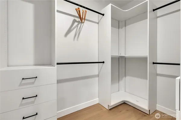 a bedroom with a bed and a night stand