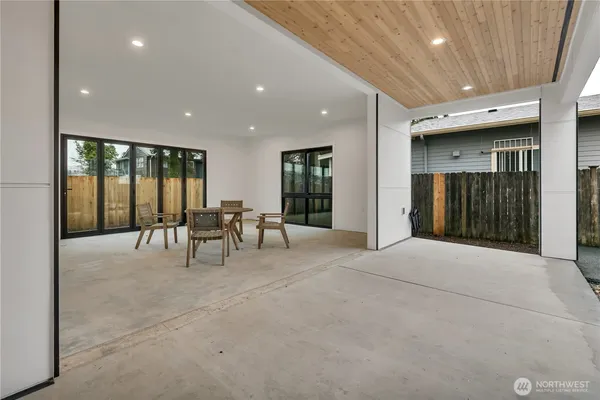 a living room with furniture and large windows