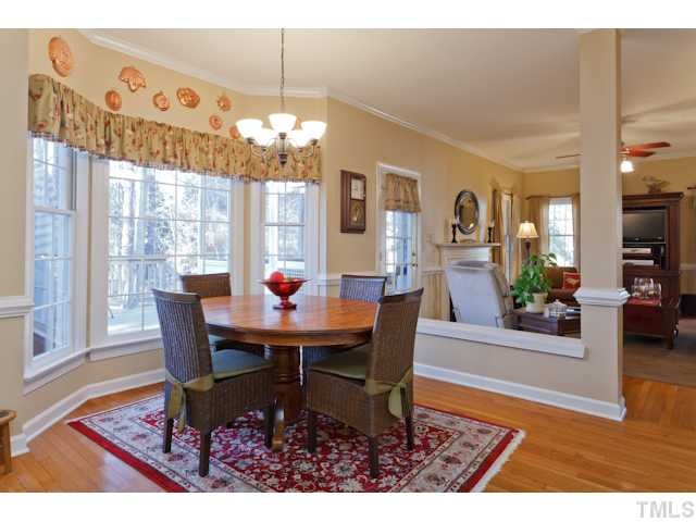 Large Breakfast Room features a Bay Window, Hardwood Floors, Updated Lighting, & fantastic view of the Private Back Yard. Breakfast Area