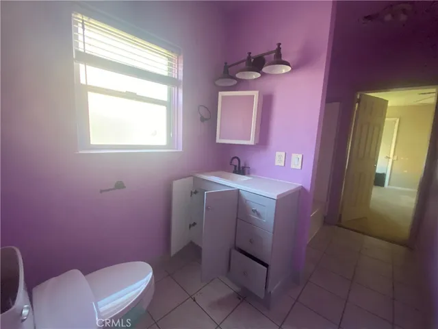 a bathroom with a sink mirror vanity and toilet