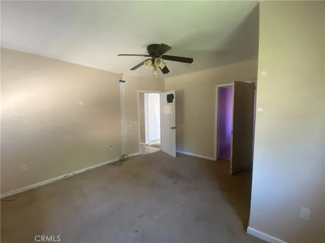 a view of a room with a ceiling fan