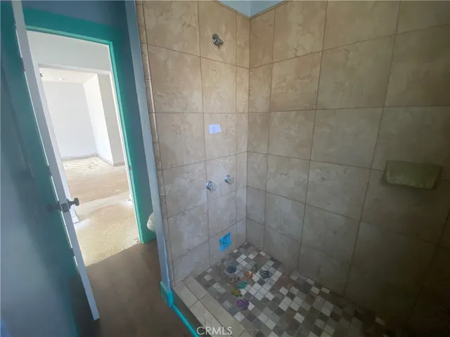a bathroom with a glass door shower