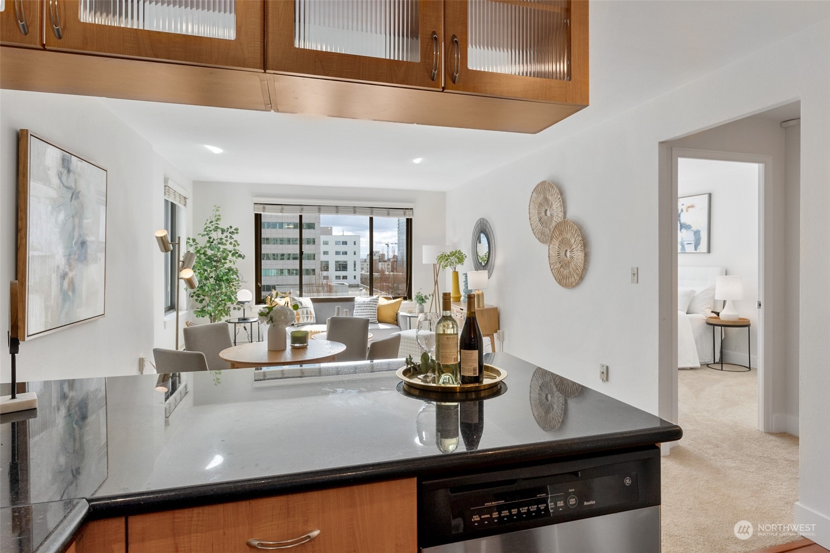 1105 Spring Street, Unit 902 Seattle, WA 98104 - Photo 11 of 21 a kitchen with a table and a clock on the wall