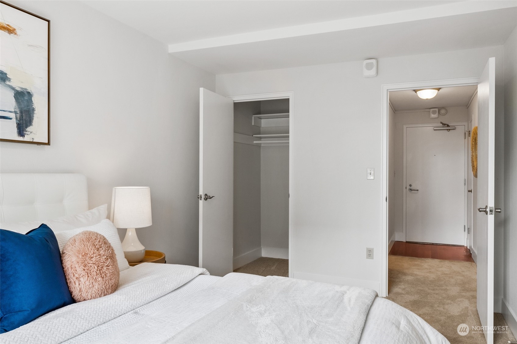 1105 Spring Street, Unit 902 Seattle, WA 98104 - Photo 16 of 21 a bedroom with a bed and lamp