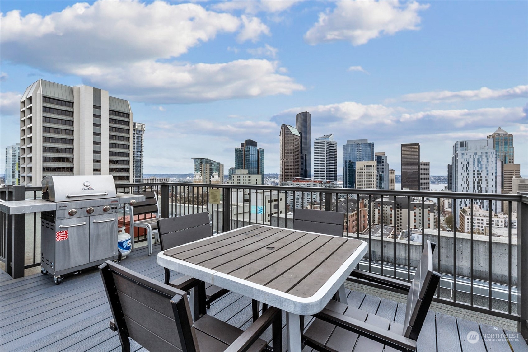 1105 Spring Street, Unit 902 Seattle, WA 98104 - Photo 17 of 21 a view of a balcony with wooden benches