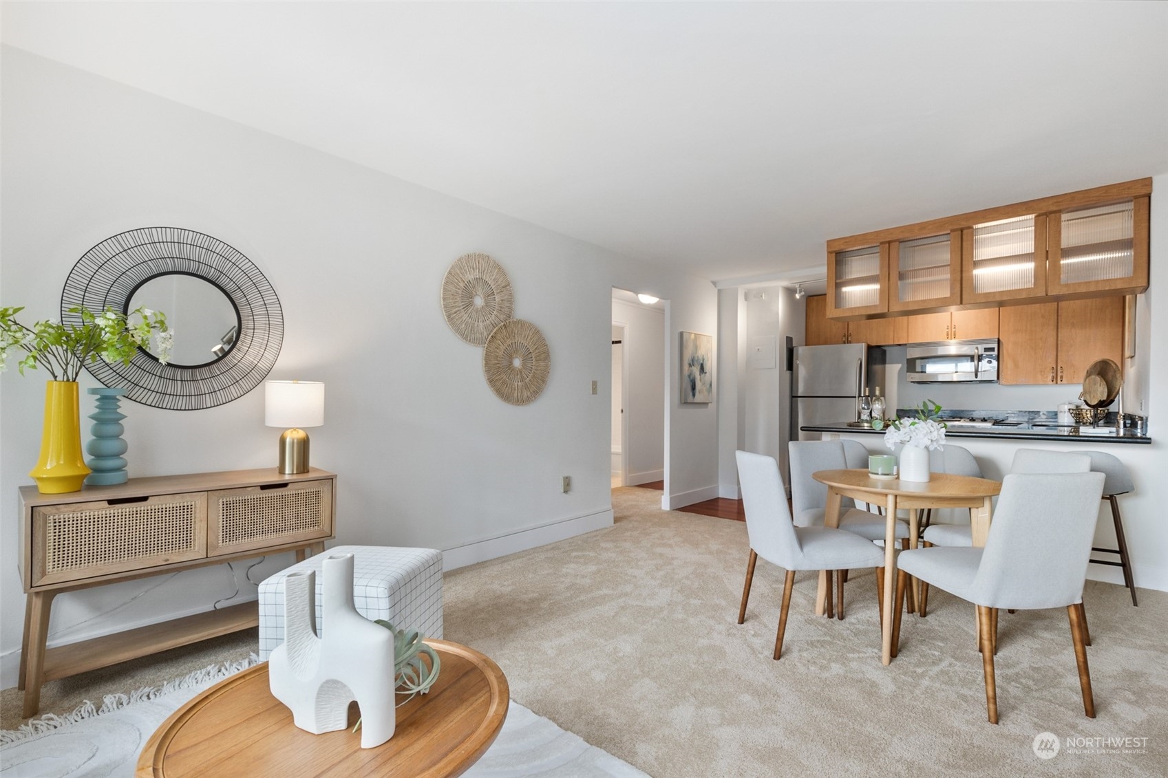 1105 Spring Street, Unit 902 Seattle, WA 98104 - Photo 6 of 21 a living room with furniture a mirror and a clock