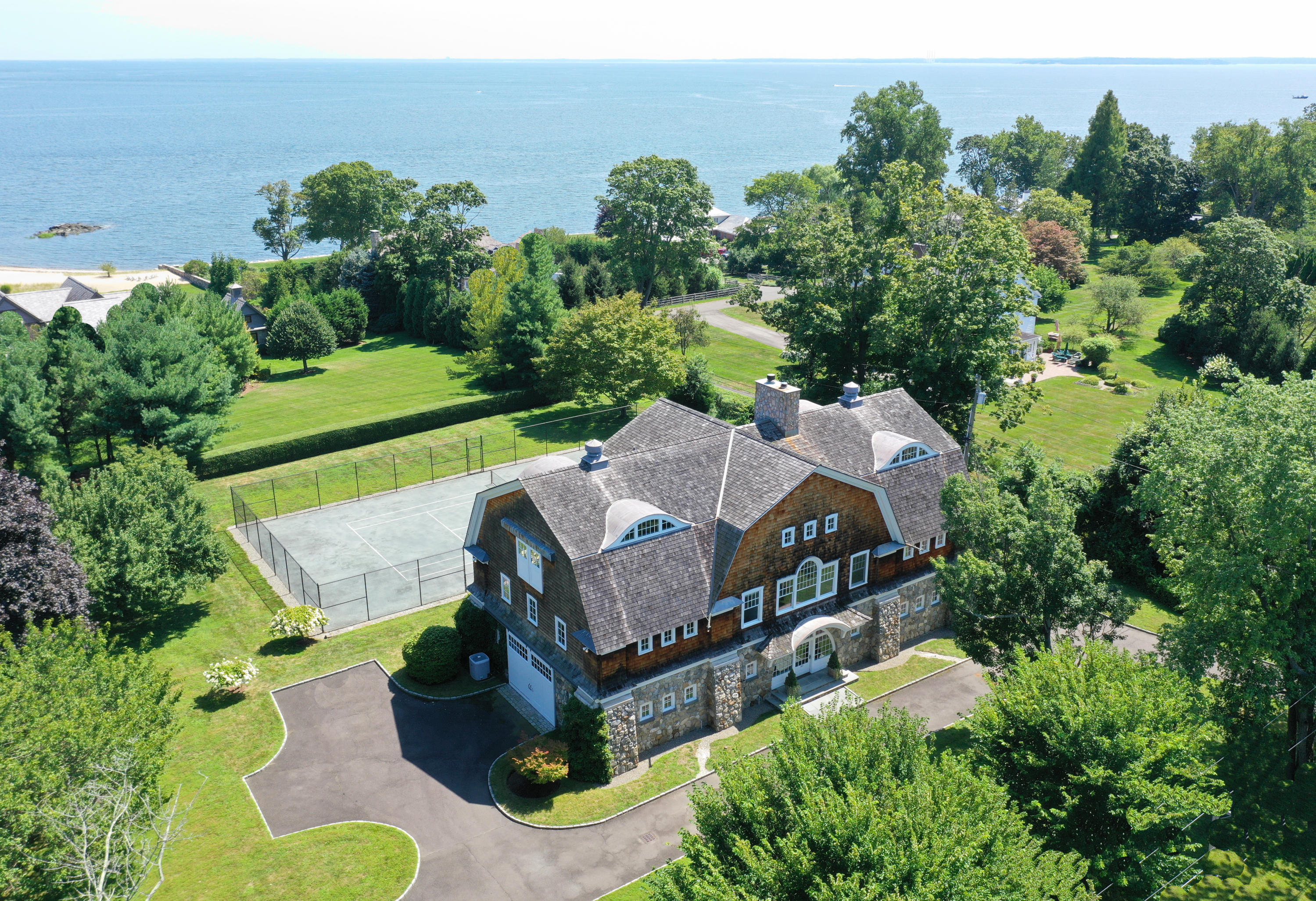 163 Long Neck Point Road Darien, CT 06820 - Photo 1 of 24 an aerial view of a house with a yard basket ball court and outdoor seating