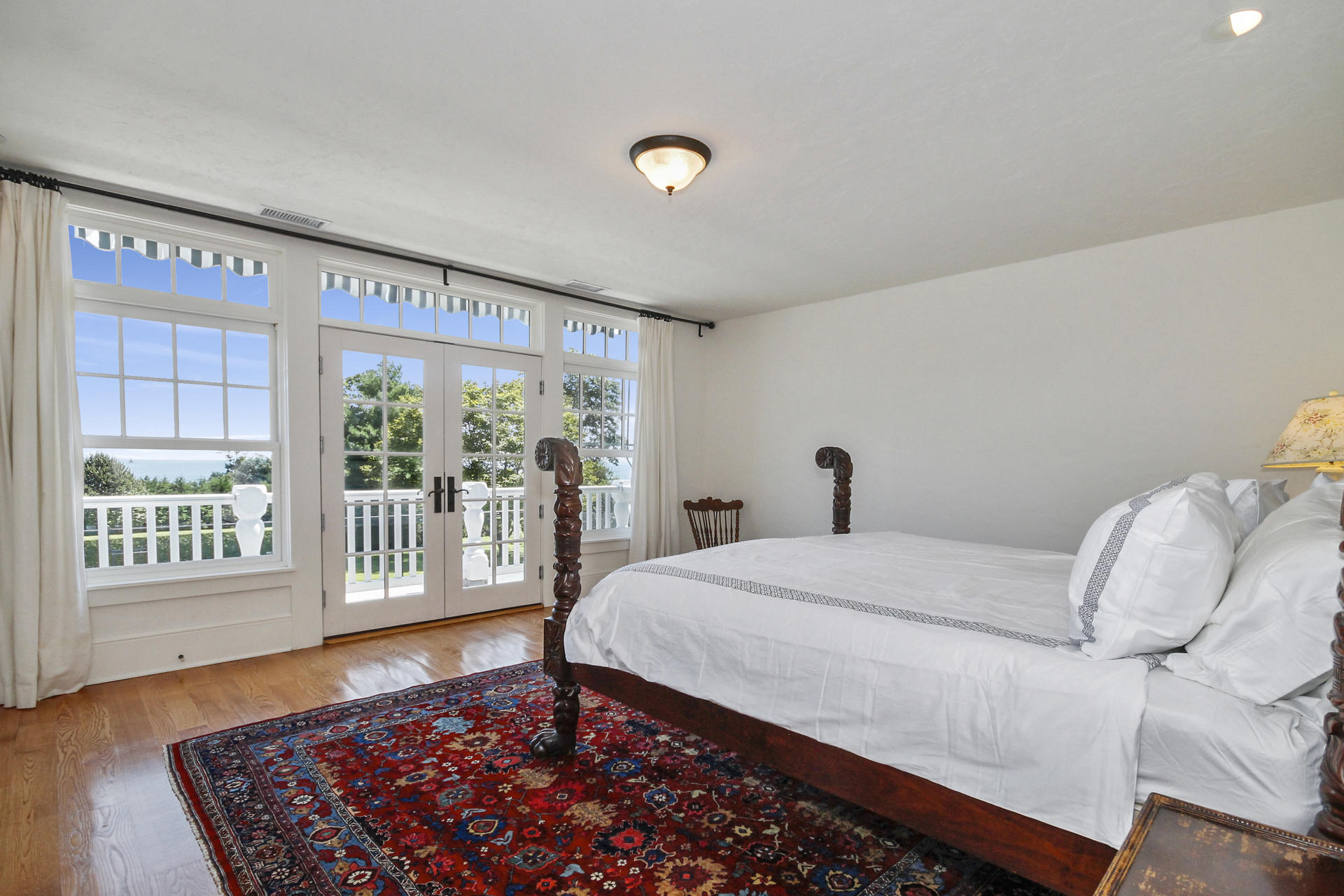 163 Long Neck Point Road Darien, CT 06820 - Photo 12 of 24 a bedroom with a bed and a large window