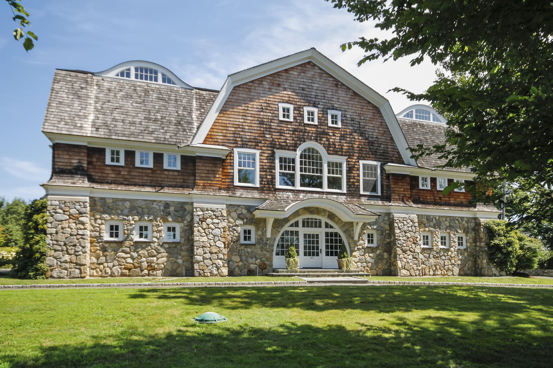 163 Long Neck Point Road Darien, CT 06820 - Photo 3 of 24 a view of a big building with a big yard and potted plants