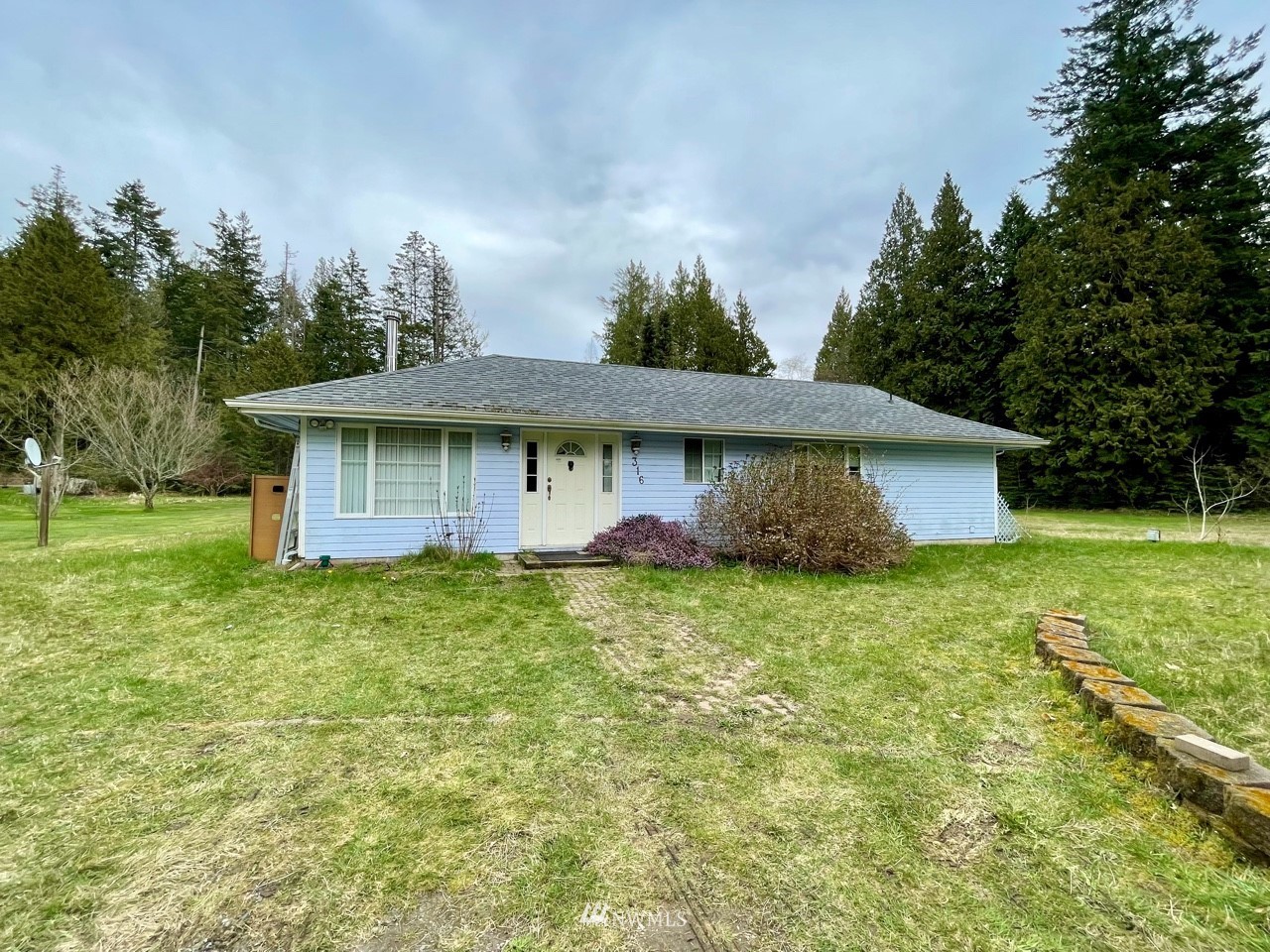 316 Mill Road Point Roberts, WA 98281 - Photo 1 of 1 a view of a house with a yard plants and large tree