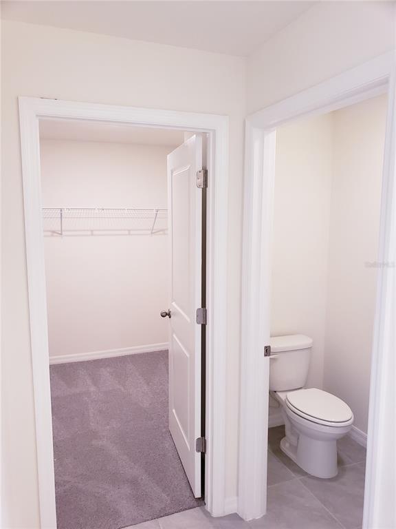 12211 Kingsley Trail Parrish, FL 34219 - Photo 26 of 28 a white toilet sitting next to a bathroom sink