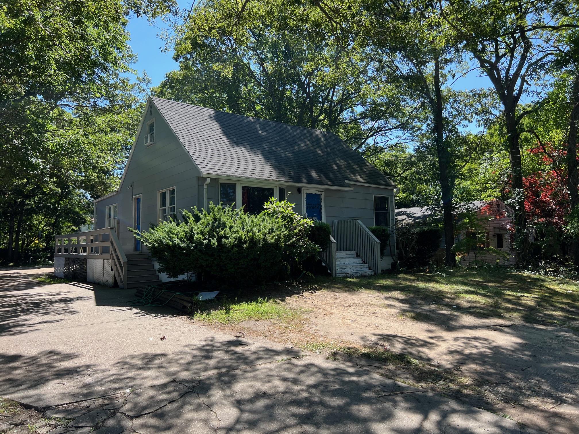 139 Madison Street Mastic, NY 11950 - Photo 1 of 1 a house that has a tree in front of it