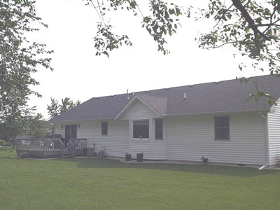 1929 Kapok Street Southwest De Motte, IN 46310 - Photo 2 of 5 a front view of a house with a garden