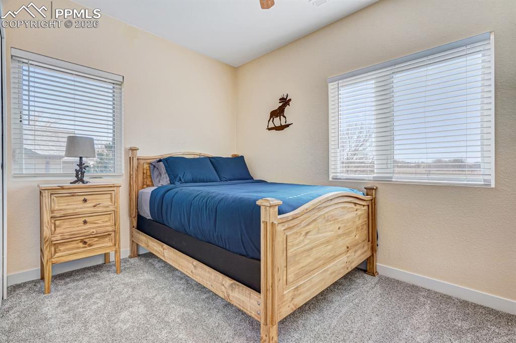10108 Rolling Ridge Road Colorado Springs, CO 80925 - Photo 20 of 32 a bedroom with a bed and a window