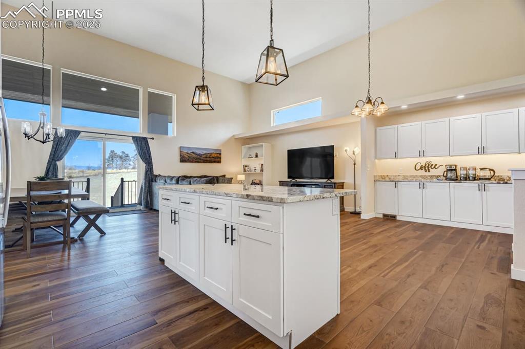 10108 Rolling Ridge Road Colorado Springs, CO 80925 - Photo 4 of 32 a large kitchen with cabinets wooden floor and stainless steel appliances