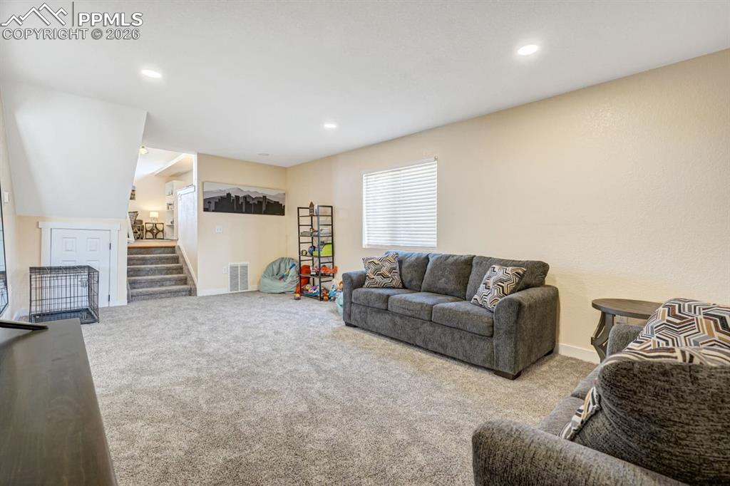 10108 Rolling Ridge Road Colorado Springs, CO 80925 - Photo 6 of 32 a living room with furniture and a window