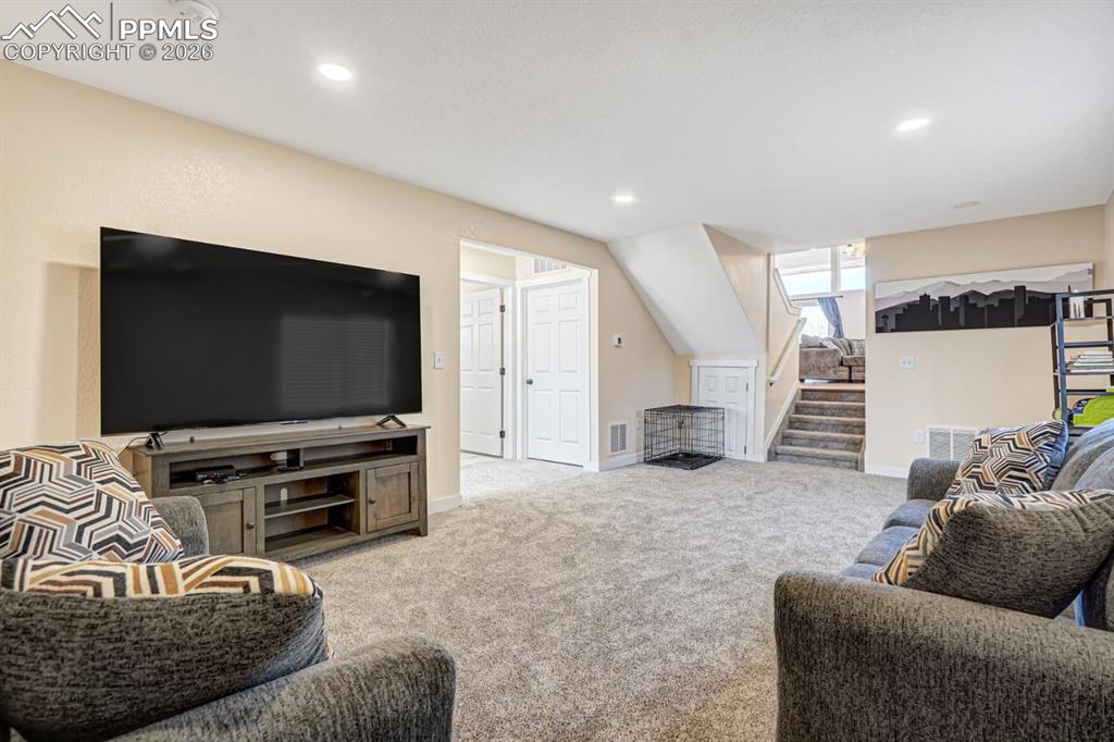10108 Rolling Ridge Road Colorado Springs, CO 80925 - Photo 7 of 32 a living room with furniture and a flat screen tv