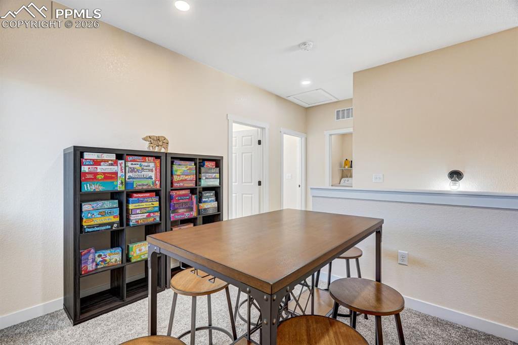 10108 Rolling Ridge Road Colorado Springs, CO 80925 - Photo 9 of 32 a view of a dining room with furniture and wooden floor