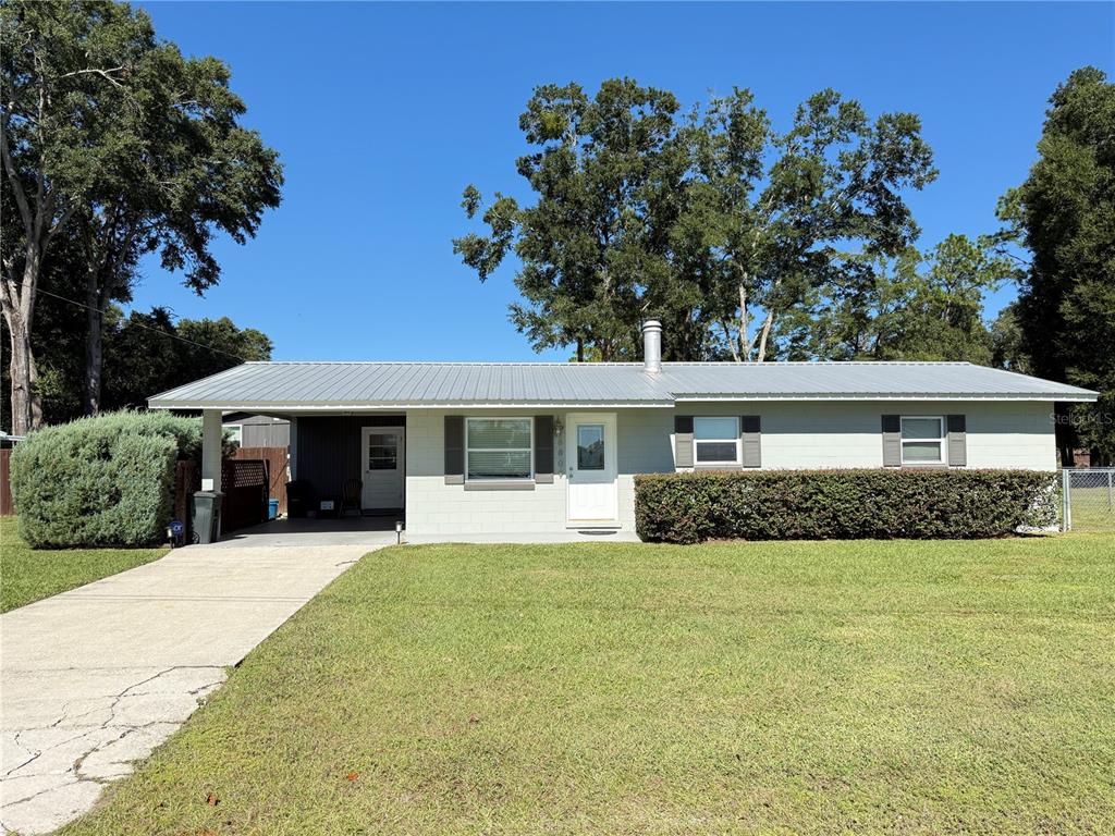 6809 Northwest 60th Street Ocala, FL 34482 - Photo 1 of 46 a view of a house with a yard and potted plants