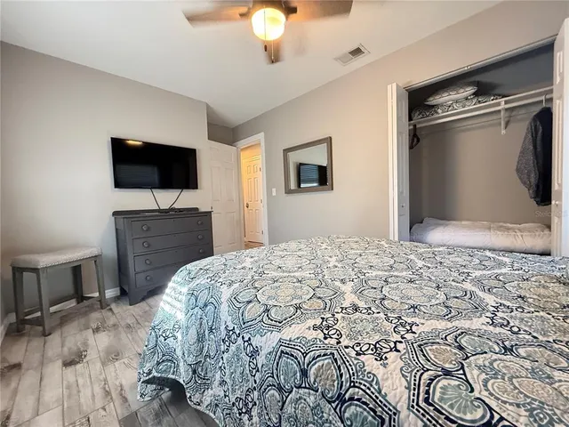 a bedroom with a large bed and a dresser