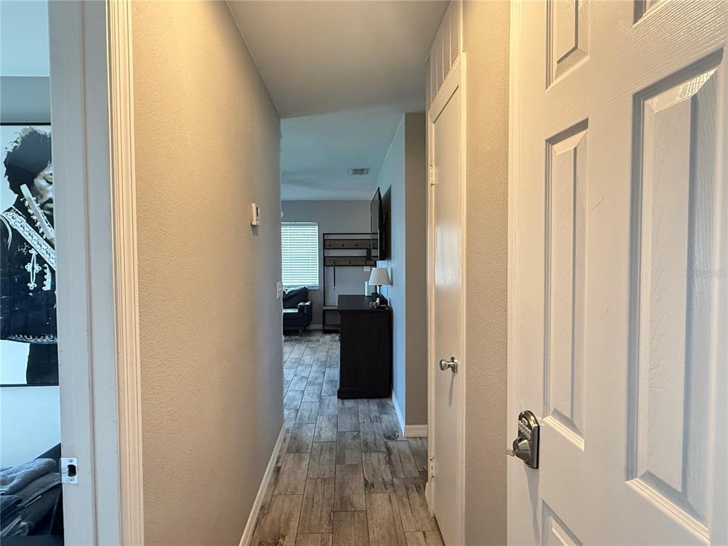 6809 Northwest 60th Street Ocala, FL 34482 - Photo 19 of 46 a view of a hallway with wooden floor and a bathroom