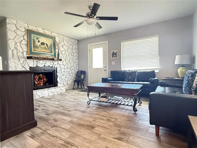 a living room with furniture a fireplace and paintings on the wall