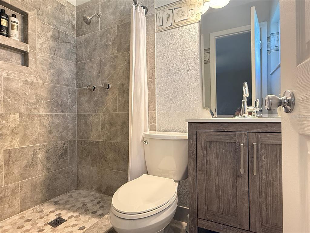 6809 Northwest 60th Street Ocala, FL 34482 - Photo 21 of 46 a bathroom with a toilet a sink a shower and a mirror