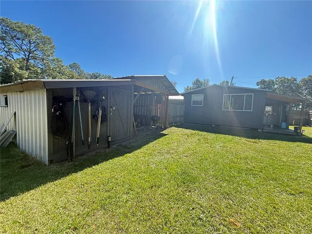 a view of a porch with furniture and floor to ceiling window