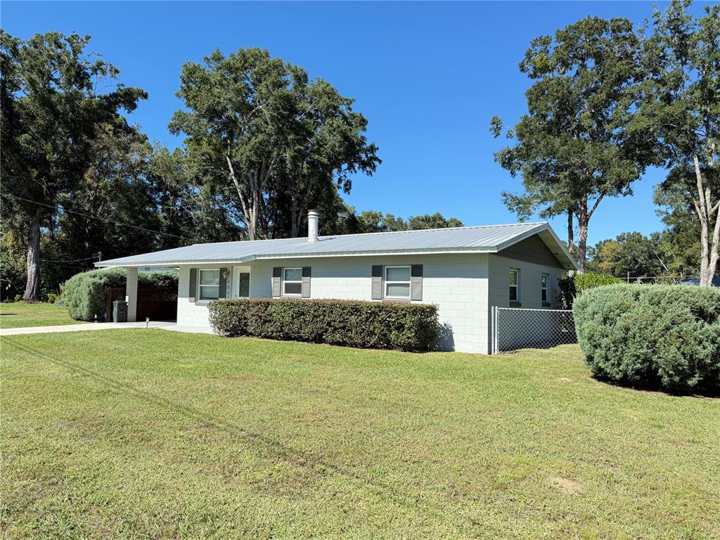 6809 Northwest 60th Street Ocala, FL 34482 - Photo 41 of 46 a front view of a house with a garden