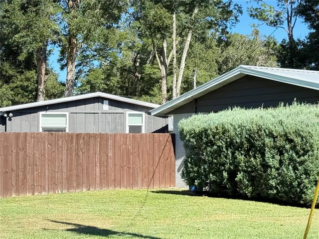 a backyard of a house with large trees