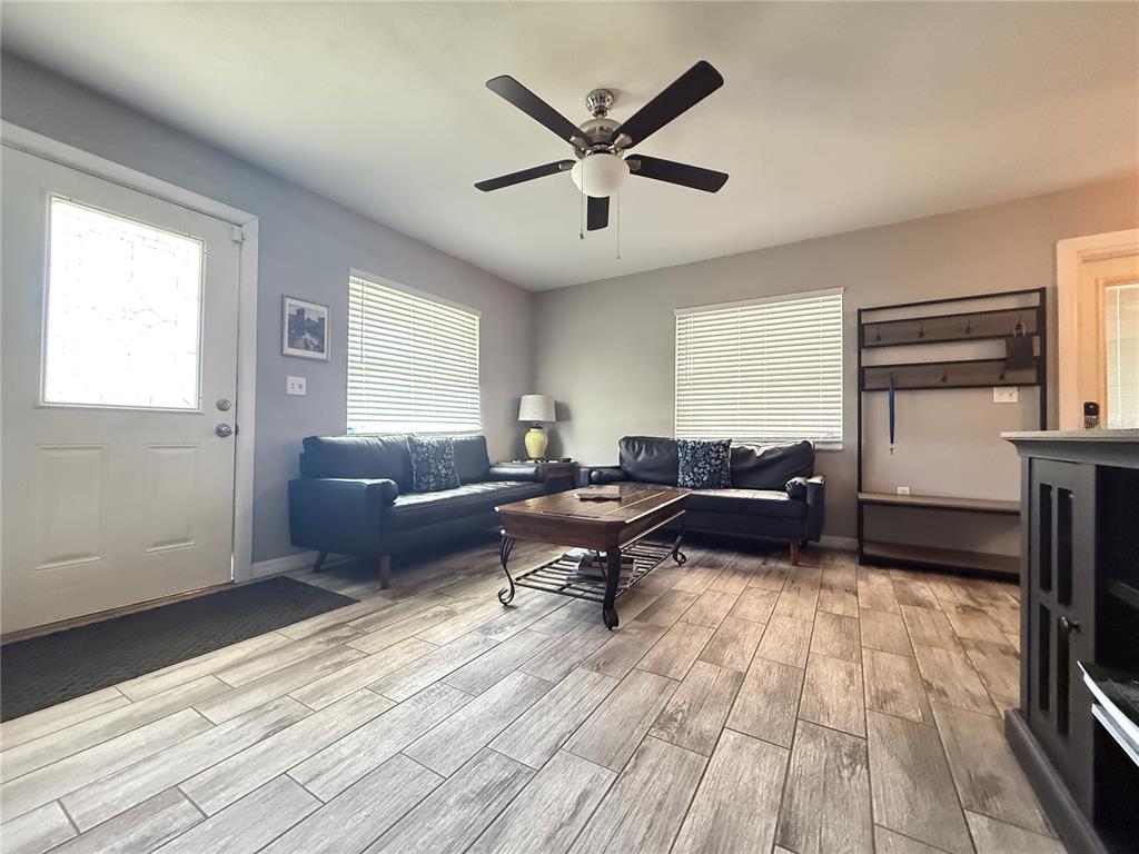 6809 Northwest 60th Street Ocala, FL 34482 - Photo 6 of 46 a living room with furniture and a wooden floor