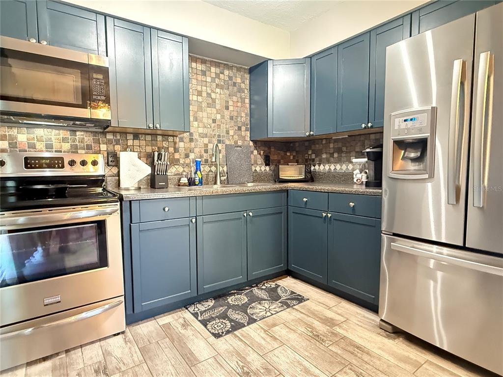 6809 Northwest 60th Street Ocala, FL 34482 - Photo 7 of 46 a kitchen with a refrigerator stove and sink