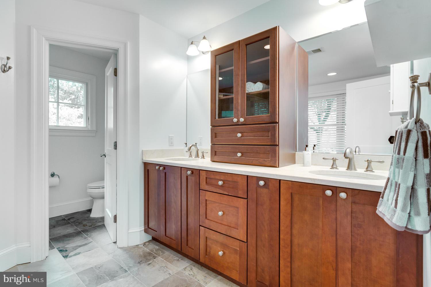 1700 Crescent Lane McLean, VA 22201 - Photo 18 of 30 a spacious bathroom with a granite countertop sink toilet and mirror