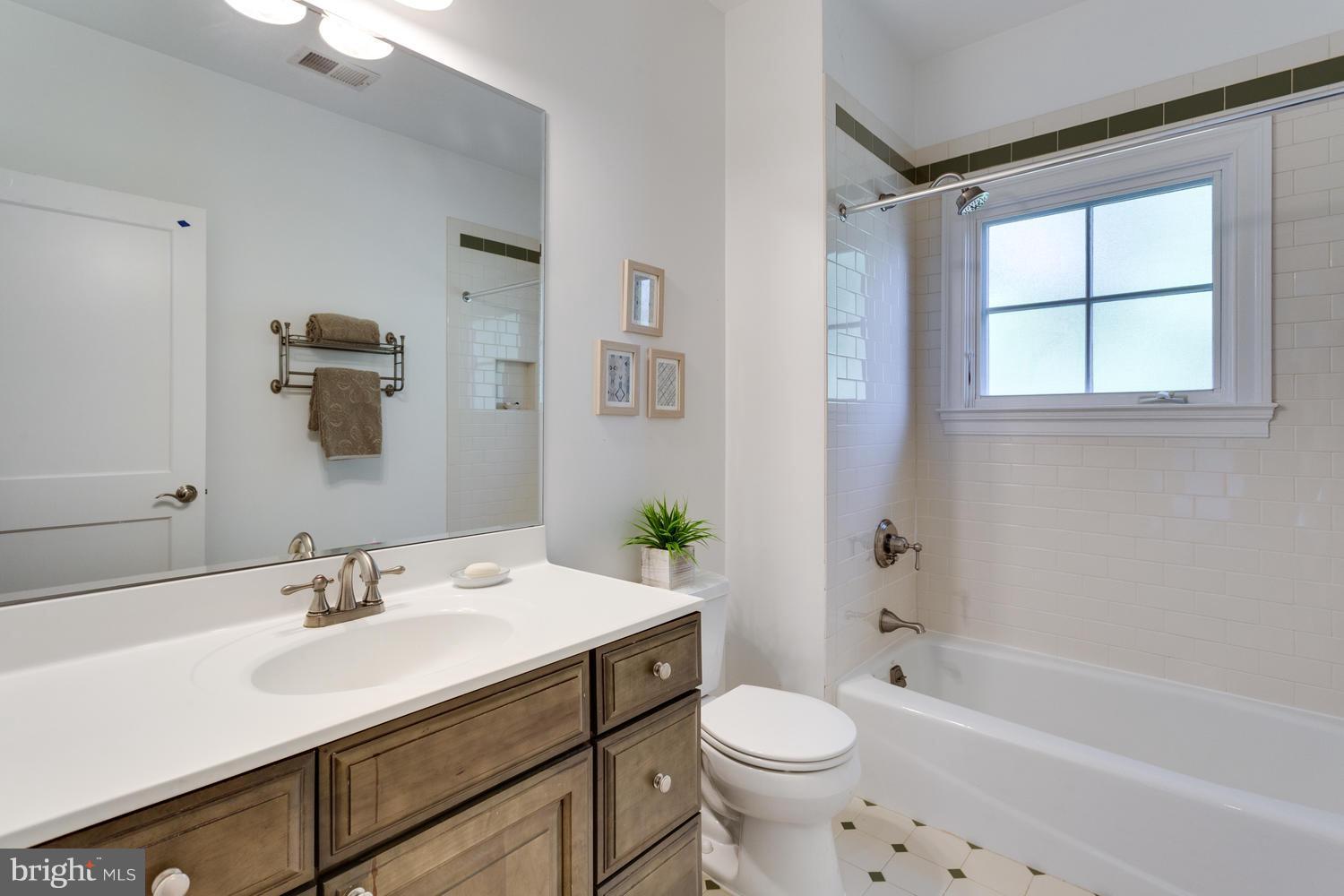 1700 Crescent Lane McLean, VA 22201 - Photo 22 of 30 a bathroom with a sink toilet a mirror and shower