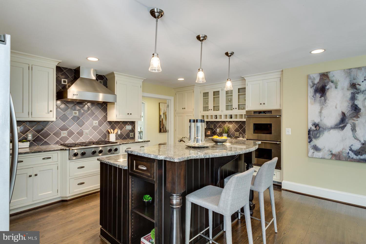 1700 Crescent Lane McLean, VA 22201 - Photo 8 of 30 a kitchen with kitchen island granite countertop a sink a center island and cabinets