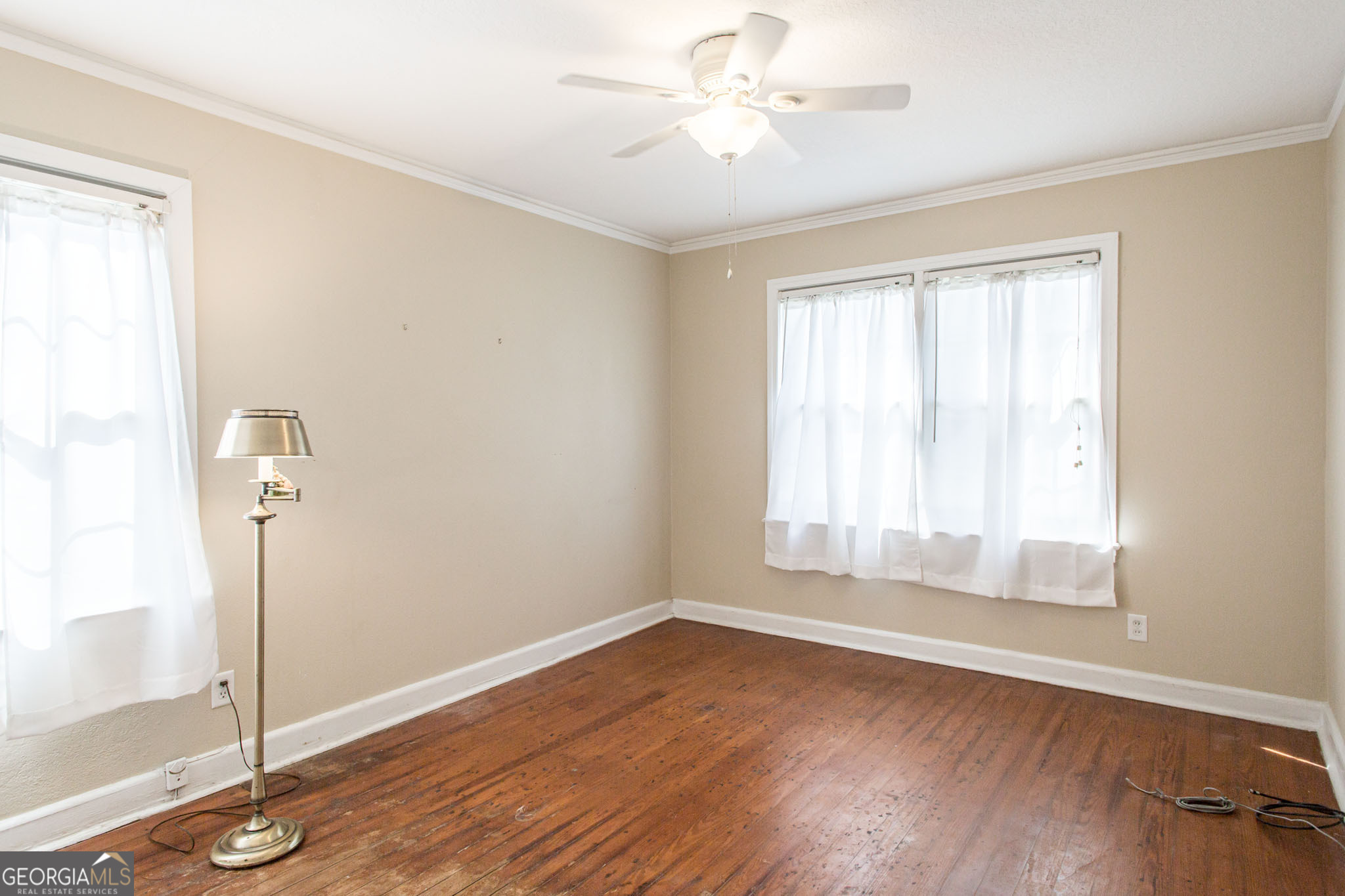 1009 Euclid Avenue Waycross, GA 31501 - Photo 24 of 35 a view of empty room with wooden floor and fan