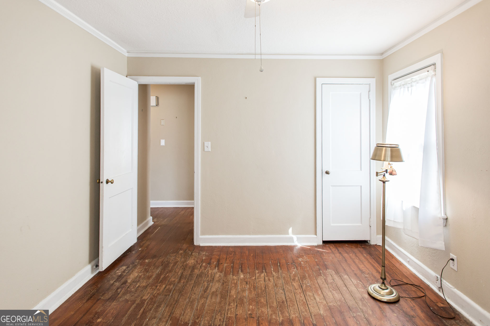 1009 Euclid Avenue Waycross, GA 31501 - Photo 25 of 35 an empty room with wooden floor and windows