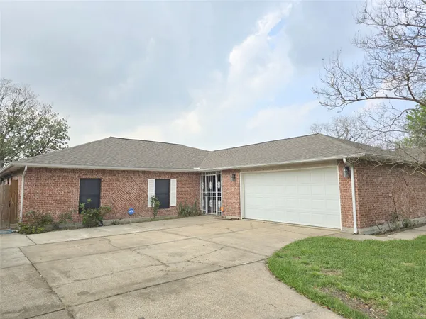a front view of a house with a garden and garage