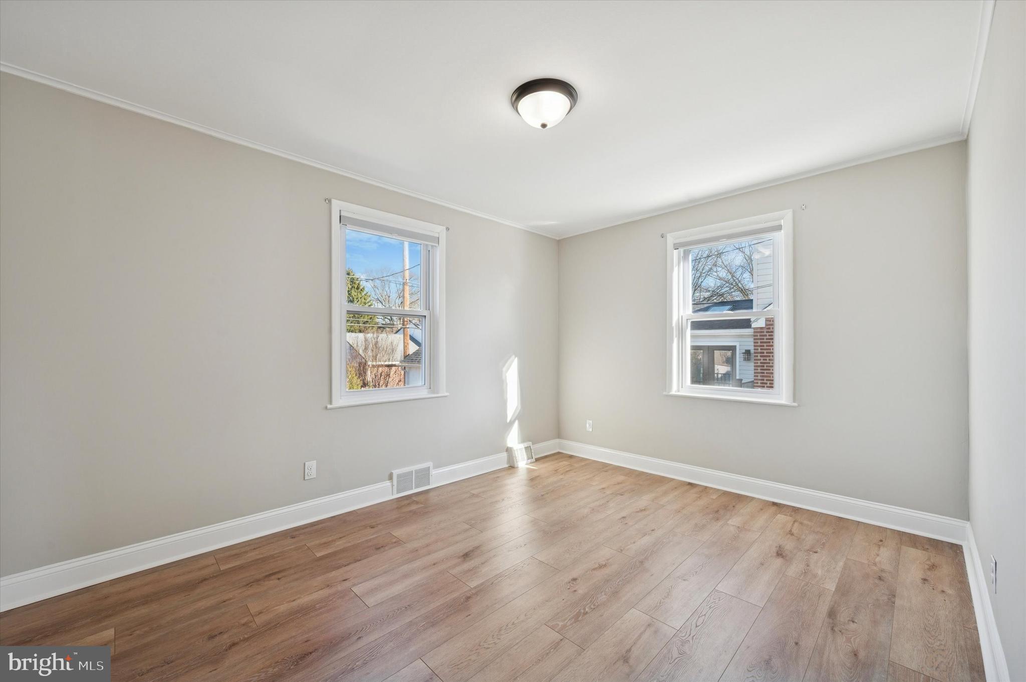 421 Lawrence Road Havertown, PA 19083 - Photo 13 of 25 a view of an empty room with wooden floor and a window