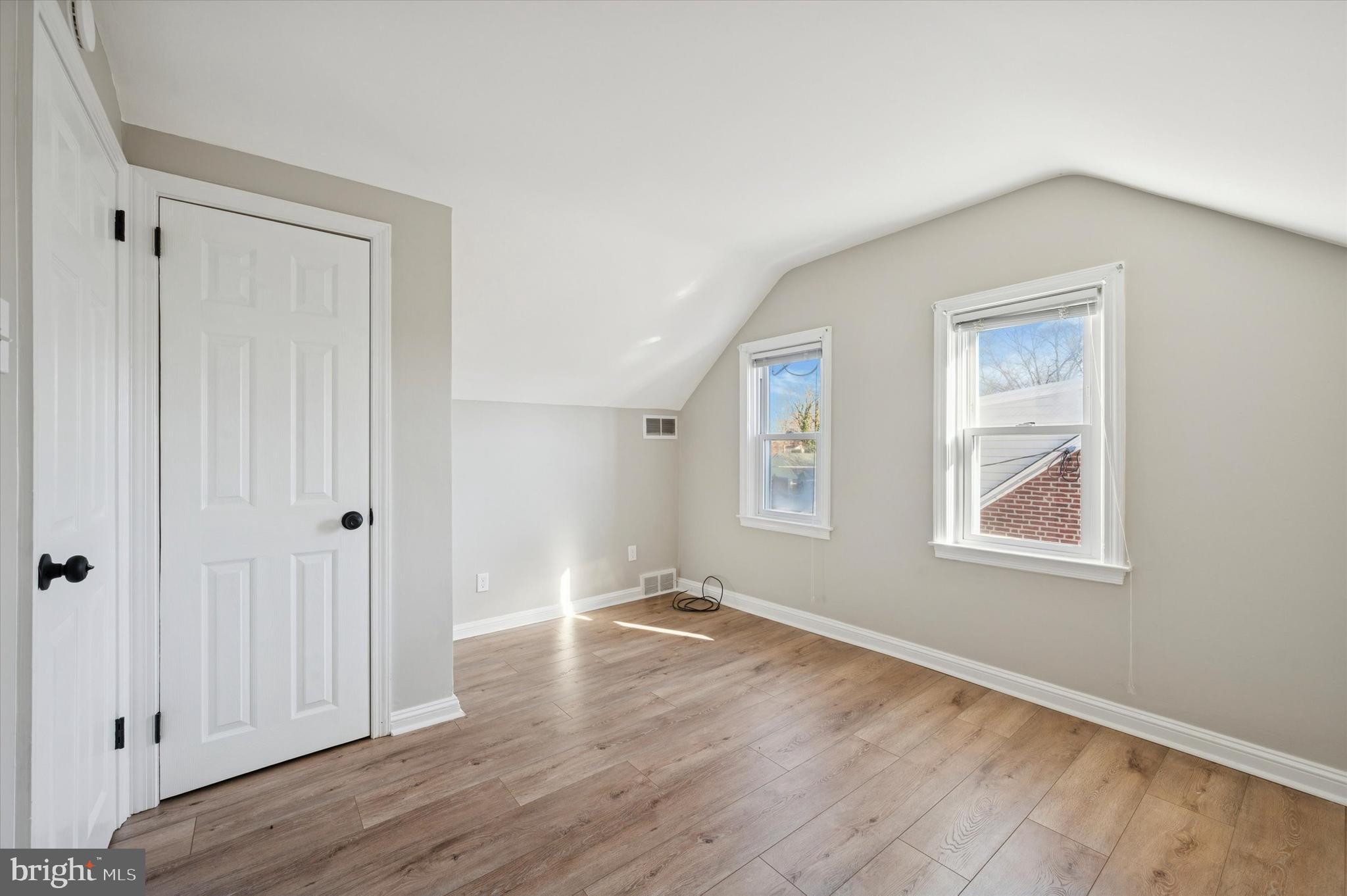 421 Lawrence Road Havertown, PA 19083 - Photo 16 of 25 a view of an empty room with wooden floor and a window