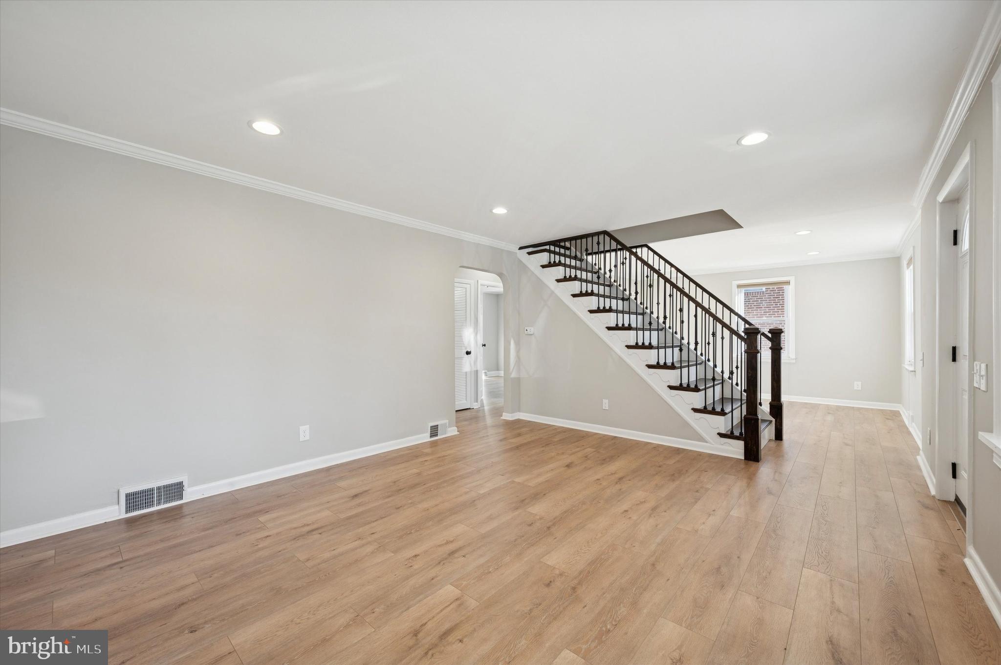 421 Lawrence Road Havertown, PA 19083 - Photo 4 of 25 a view of an empty room with wooden floor and stairs