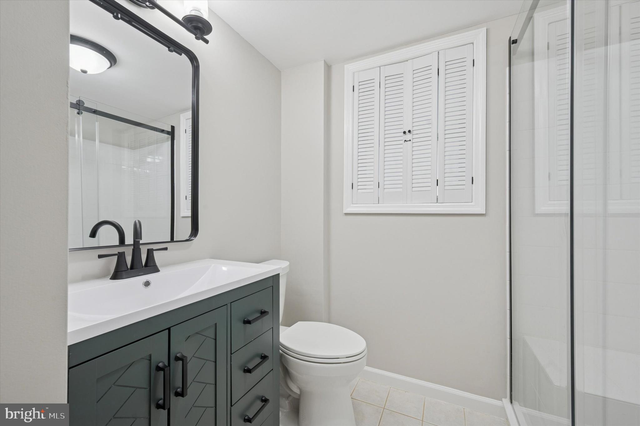 421 Lawrence Road Havertown, PA 19083 - Photo 9 of 25 a bathroom with a sink a toilet and a mirror