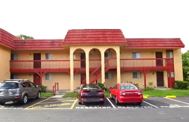 a red car parked in front of a building