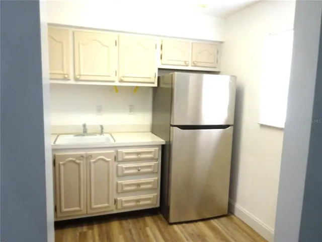 a kitchen with a refrigerator and a sink